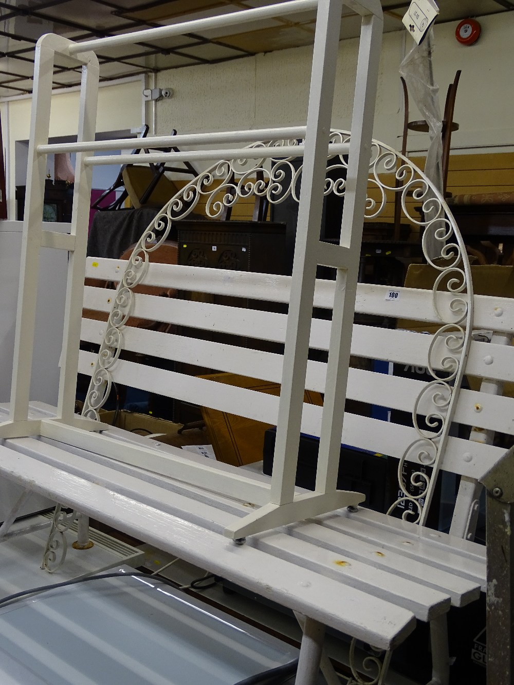Wooden and metal white painted garden bench, a decorative metal arch and a towel airer