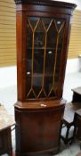 A reproduction mahogany effect standing corner cabinet with glazed top Condition reports provided on