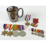 A regimental half-pint EPNS mug containing a bar of four WWII medals (unnamed), similar miniatures &