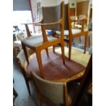An oval / circular Danish mid-century dining table and six chairs with padded seats and backs