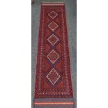 A rust coloured and blue Meshwani runner, 248 x 61cms Condition reports provided on request by email