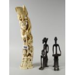 A Meiji carved ivory stack-group of a jolly father & his two children with bird atop and two