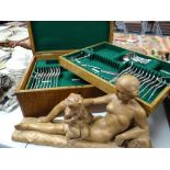 A vintage oak encased part canteen of cutlery & a composition sculpture Condition reports provided