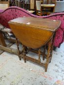 A small barley-twist drop leaf table Condition reports provided on request by email for this auction