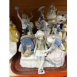 A Lladro group of children reading, a Lladro group of a boy teasing a girl with a ball, a Lladro