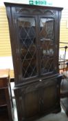 A lunette carved reproduction corner cabinet with glazed top Condition reports provided on request