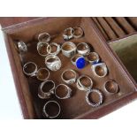 A modern jewellery box with drawers containing a collection of white metal / silver dress rings,