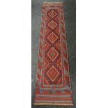 A rust and blue patterned Meshwani runner, 260 x 60cms Condition reports provided on request by