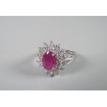 An 18ct white gold set ruby (1ct approx.) and diamonds (1ct total) floral ring Condition reports