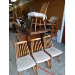 A set of four spindle back mid-century lightwood chairs, an occasional table with reeded supports