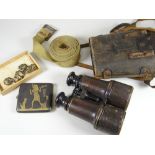 A pair of early twentieth century Bloom Ltd binoculars, a military belt, Egyptian cigarette case ETC