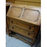 A panelled two-drawer oak bureau Condition reports provided on request by email for this auction