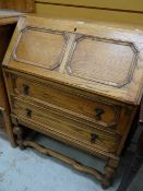 A panelled two-drawer oak bureau Condition reports provided on request by email for this auction
