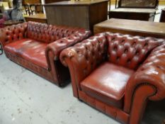 A cherry-red vintage Chesterfield settee and matching armchair Condition reports provided on request