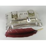 A good silver desk stand of shaped form on bun feet and with two square based glass inkwells with