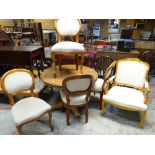 Mixed wood circular breakfast table together with set of four spoon-back dining chairs and open