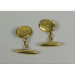 PAIR OF 18CT YELLOW GOLD CUFFLINKS WITH ENGRAVED GREYHOUND ARMORIAL. 7.6 grams approximately. (2)