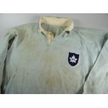 A 1957 ONTARIO RUGBY UNION JERSEY NUMBERED 18 having a birds-egg blue body with white collars and