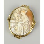 CARVED CAMEO BROOCH DEPICTING ROBED LADY WITH BIRD OF PREY in yellow metal setting Condition Report: