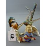 Two Goebel china bird figurines one of a kingfisher and a small Goebel angelic figurine playing a