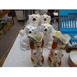 Pair of Staffs red and white 'begging' dog jugs with floral rims (damage to both) and two pairs of