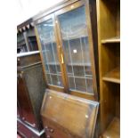 1930's bookcase bureau having two leaded and glazed doors to the top with shaped panes, centre
