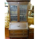 Polished wood bureau bookcase with twin lead glazed doors