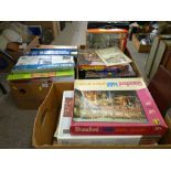 Three boxes of various jigsaws