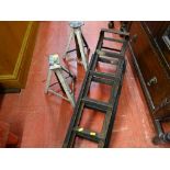 Pair of mechanic's car ramps and white painted axle stands