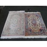 Ffrith Chinese washed floral rug and a cream and blue bordered rug with tasselled ends