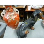 Heavy porcelain dachshund and a narrow necked vase