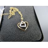 Nine carat gold double heart pendant with fine link necklace, one heart set with twelve tiny