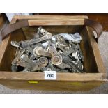 Wooden box of mixed ironmongery items (stair rod fixings?)