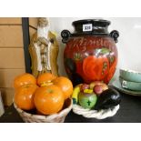 Oriental figure, faux fruit basket ornament and a Rumtopf jar