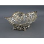 AN OVAL SHAPED PEDESTAL SILVER BASKET having extensive lattice and scrolled decoration on a floral