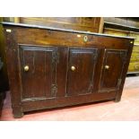 AN ANTIQUE OAK COFFER with iron strap hinges to the top, peg joined panel sides and triple chamfered