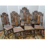 A GOOD SET OF SEVEN (SIX PLUS ONE) VICTORIAN OAK DINING CHAIRS with lion crested top rails, turned