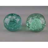 TWO VICTORIAN GREEN GLASS DUMP PAPERWEIGHTS, one having inkwell top, both with bubble inclusions