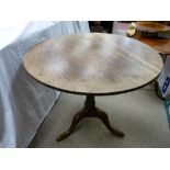 AN ANTIQUE OAK TILT TOP TRIPOD TABLE, 72 cms high, 80 cms diameter the top (catch button absent