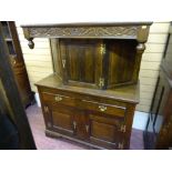 A REPRODUCTION OAK BUFFET SIDEBOARD with carved top frieze and fancy brass 'H' hinges, 148 cms high,