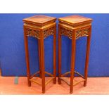 A PAIR OF 20th CENTURY CHINESE HARDWOOD STANDS with fruit and vine side decoration, 91.5 cms high,