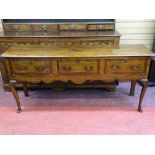 A 19th CENTURY OAK SHROPSHIRE DRESSER BASE, the planked top over three crossbanded and string inlaid