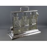 A WALKER & HALL SILVER PLATED THREE BOTTLE TANTALUS, the decanters and stoppers numbered 1, 2 and