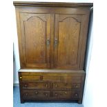 A GEORGE III OAK PRESS CUPBOARD, the interior peg fitted for hanging, peg joined construction,