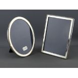 TWO MODERN HALLMARKED SILVER EASEL PHOTOGRAPH FRAMES to include a 20.5 x 15.5 cms oval, Sheffield