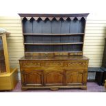 A GEORGE III OAK & ELM SPICE DRAWER NORTH WALES DRESSER, the three shelf rack with decorative canopy