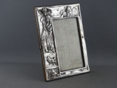 A SILVER REPOUSSE DECORATED EASEL PORTRAIT FRAME, Birmingham 1909, maker Israel Sigmund Greenberg,