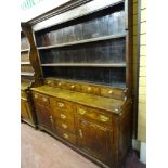 A GEORGE III NORTH WALES OAK SPICE DRAWER DRESSER, the three shelf wide boarded rack having five