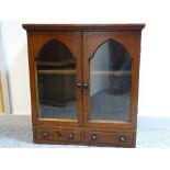 A 19th CENTURY PINE TABLETOP CABINET having twin glazed doors with arched top detail and a pair of