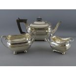 A THREE PIECE SILVER TEA SERVICE, each piece of oblong plain form with lined decoration on four ball